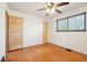 Bedroom featuring hardwood floors, a ceiling fan, and a window at 3580 Locust St, Denver, CO 80207