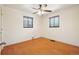 Simple bedroom with hardwood floors and two windows offering natural light at 3580 Locust St, Denver, CO 80207