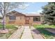 Brick home with a walkway to the front door. Bench on the front porch at 3580 Locust St, Denver, CO 80207