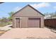 Exterior view of a private garage and brick paved parking area at 3580 Locust St, Denver, CO 80207