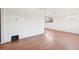 Bright living room with hardwood floors and a window offering natural light at 3580 Locust St, Denver, CO 80207