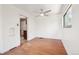 Light-filled room with hardwood floors, ceiling fan, and a glimpse of the kitchen at 3580 Locust St, Denver, CO 80207