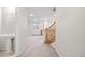 Hallway view featuring a staircase and a bathroom with pedestal sink at 3810 Urban St, Wheat Ridge, CO 80033