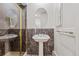 Bathroom features a pedestal sink and glass-enclosed shower with dark marble-style tiling at 3810 Urban St, Wheat Ridge, CO 80033