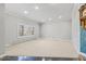 Large living room with neutral carpet and a wall of windows to let in natural light at 3810 Urban St, Wheat Ridge, CO 80033