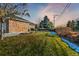 Landscaped side yard with brick wall and walkway at 3810 Urban St, Wheat Ridge, CO 80033