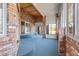 Spacious sunroom with brick walls and carpeted floor at 3810 Urban St, Wheat Ridge, CO 80033