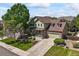 Aerial view of a spacious two-story home with a well-manicured lawn, mature trees, and a long driveway at 13445 Kearney St, Thornton, CO 80602