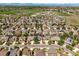 Aerial view showcasing houses with solar panels nestled in a community with tree-lined streets at 13445 Kearney St, Thornton, CO 80602