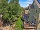 Well-maintained backyard featuring a deck, a playhouse, and lush green lawn at 13445 Kearney St, Thornton, CO 80602