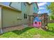 Backyard view of a playhouse with wooden support beams at 13445 Kearney St, Thornton, CO 80602