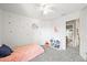 Cozy bedroom with moon and star wall decor, plush carpet, and a playful ambiance at 13445 Kearney St, Thornton, CO 80602