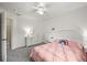 Bright bedroom featuring neutral walls, carpet floor, white furniture, and a decorative rainbow pillow on the bed at 13445 Kearney St, Thornton, CO 80602
