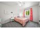 Charming bedroom with a plush bed, ceiling fan, carpet flooring, and a window with decorative pink curtains at 13445 Kearney St, Thornton, CO 80602