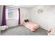Inviting bedroom featuring whimsical moon and star wall decor, with plush carpet for comfort at 13445 Kearney St, Thornton, CO 80602