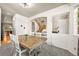 The dining area offers a view to the living room and staircase with bright light from the front window at 13445 Kearney St, Thornton, CO 80602