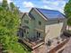 Two-story home featuring solar panels, a deck, a playhouse and well-maintained landscaping at 13445 Kearney St, Thornton, CO 80602