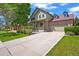 Charming two-story home featuring a brick facade, covered porch, manicured lawn and attached two car garage at 13445 Kearney St, Thornton, CO 80602