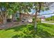 Charming two-story home showcasing a well-maintained lawn, mature trees, and inviting curb appeal at 13445 Kearney St, Thornton, CO 80602
