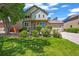 Beautiful two-story home with brick and siding exterior, well-manicured lawn, and mature landscaping at 13445 Kearney St, Thornton, CO 80602