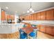 Spacious kitchen featuring wooden cabinets, light countertops, stainless appliances, and a dining area, great for entertaining at 13445 Kearney St, Thornton, CO 80602