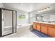 Beautiful primary bathroom featuring a glass-enclosed shower, soaking tub, and double vanity at 13445 Kearney St, Thornton, CO 80602