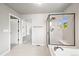 Bathroom featuring a shower, tub, and views of the bedroom with carpet at 13445 Kearney St, Thornton, CO 80602