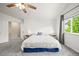 Bright and airy bedroom with neutral tones, ceiling fan, large window, and ensuite access at 13445 Kearney St, Thornton, CO 80602