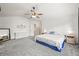 Large bedroom featuring neutral paint, ceiling fan, ensuite bathroom, walk-in closet, and ample space at 13445 Kearney St, Thornton, CO 80602
