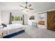 Spacious bedroom boasts vaulted ceilings, ceiling fan, barn door and abundant natural light at 13445 Kearney St, Thornton, CO 80602