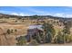 Stunning aerial view of home near a pond and open land, with solar panels visible at 7082 Silverhorn Dr, Evergreen, CO 80439