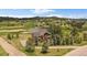 Aerial view of the property, including a pond, surrounded by greenery at 7082 Silverhorn Dr, Evergreen, CO 80439
