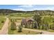 Scenic aerial of home and grounds, complete with solar panels and pond at 7082 Silverhorn Dr, Evergreen, CO 80439
