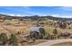 Beautiful aerial shot of the community pond near multiple homes and scenic mountain views at 7082 Silverhorn Dr, Evergreen, CO 80439
