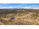 An aerial community shot overlooking the pond, tennis courts and mountain ranges from afar at 7082 Silverhorn Dr, Evergreen, CO 80439