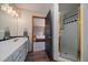Bathroom featuring a single vanity and shower with tiled walls at 7082 Silverhorn Dr, Evergreen, CO 80439