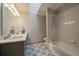 Bathroom featuring decorative tile flooring, a shower-tub combo, and a vanity with modern fixtures at 7082 Silverhorn Dr, Evergreen, CO 80439