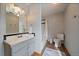 Well-lit bathroom featuring a shower and tub combo plus a single sink with a large mirror at 7082 Silverhorn Dr, Evergreen, CO 80439