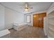 A bright bedroom with carpet flooring features a ceiling fan, closet, and a single window with natural light at 7082 Silverhorn Dr, Evergreen, CO 80439