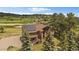View of exterior elevation featuring a stone facade and solar panels at 7082 Silverhorn Dr, Evergreen, CO 80439
