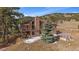 Two-story home featuring a private deck and a beautiful yard with mature trees at 7082 Silverhorn Dr, Evergreen, CO 80439