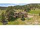Charming home with a balcony, lush lawn, and a picturesque treed surrounding at 7082 Silverhorn Dr, Evergreen, CO 80439