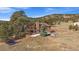 Two-story house featuring a balcony and views of the surrounding wooded landscape, showcasing its tranquil setting at 7082 Silverhorn Dr, Evergreen, CO 80439