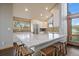 Modern kitchen with stainless steel appliances, white cabinets, and a large island at 7082 Silverhorn Dr, Evergreen, CO 80439