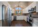 Bright kitchen features stainless appliances, white cabinetry, granite countertops, and large window at 7082 Silverhorn Dr, Evergreen, CO 80439