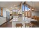 Bright kitchen with granite countertops, wood floors, stainless steel appliances, and large windows at 7082 Silverhorn Dr, Evergreen, CO 80439