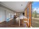 Open-concept living area with hardwood floors and large windows showcasing the beautiful outdoor view at 7082 Silverhorn Dr, Evergreen, CO 80439
