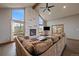 Cozy living room with stone fireplace, hardwood floors, and a large sectional sofa at 7082 Silverhorn Dr, Evergreen, CO 80439