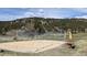 Outdoor sand volleyball court on the property surrounded by trees and scenic views at 7082 Silverhorn Dr, Evergreen, CO 80439