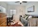 Stylish bedroom features a daybed with decorative pillows, a workspace, and warm wood flooring at 1010 S Newton St, Denver, CO 80219